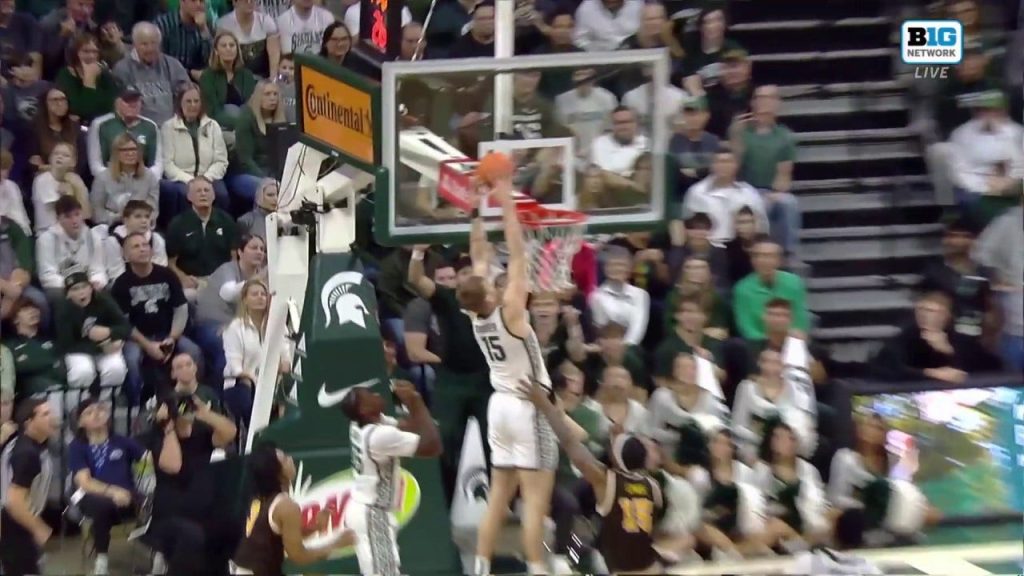 Carson Cooper dari Michigan State melakukan alley-oop dengan dua tangan untuk memperluas keunggulan atas Michigan Barat